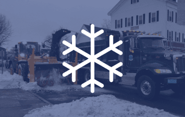 Snowflake over image of snowplow